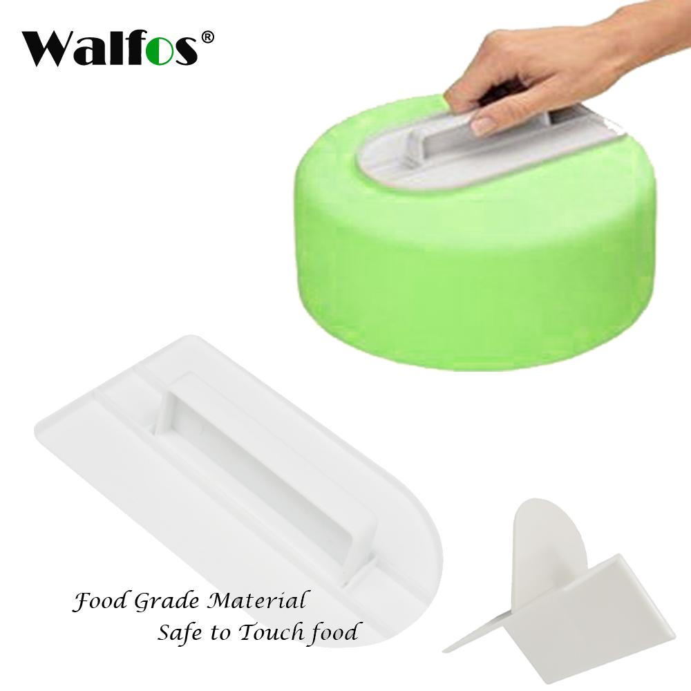 Green food dehydrator with a hand placing food inside, surrounded by white components on a white background.